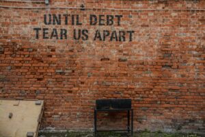 until debt tears us apart on wall