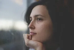 woman staring out the window